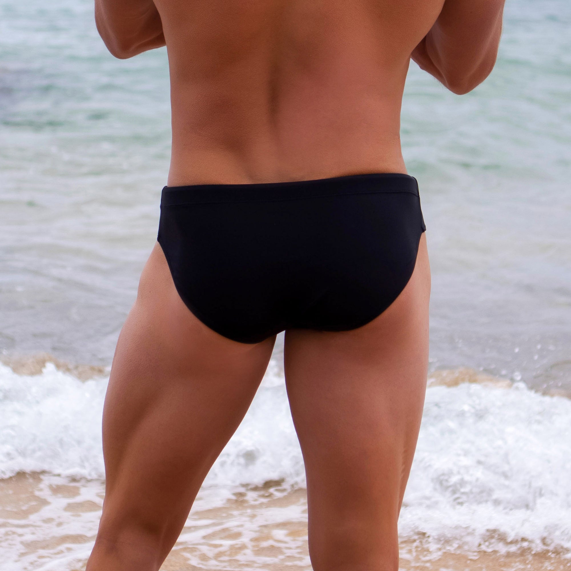 Black swimwear brief in midnight black colour model shot from back