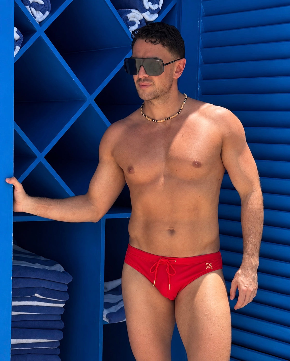 Man wearing the Apollo Swim Brief in Chilli Red by Archer Swimwear, front view