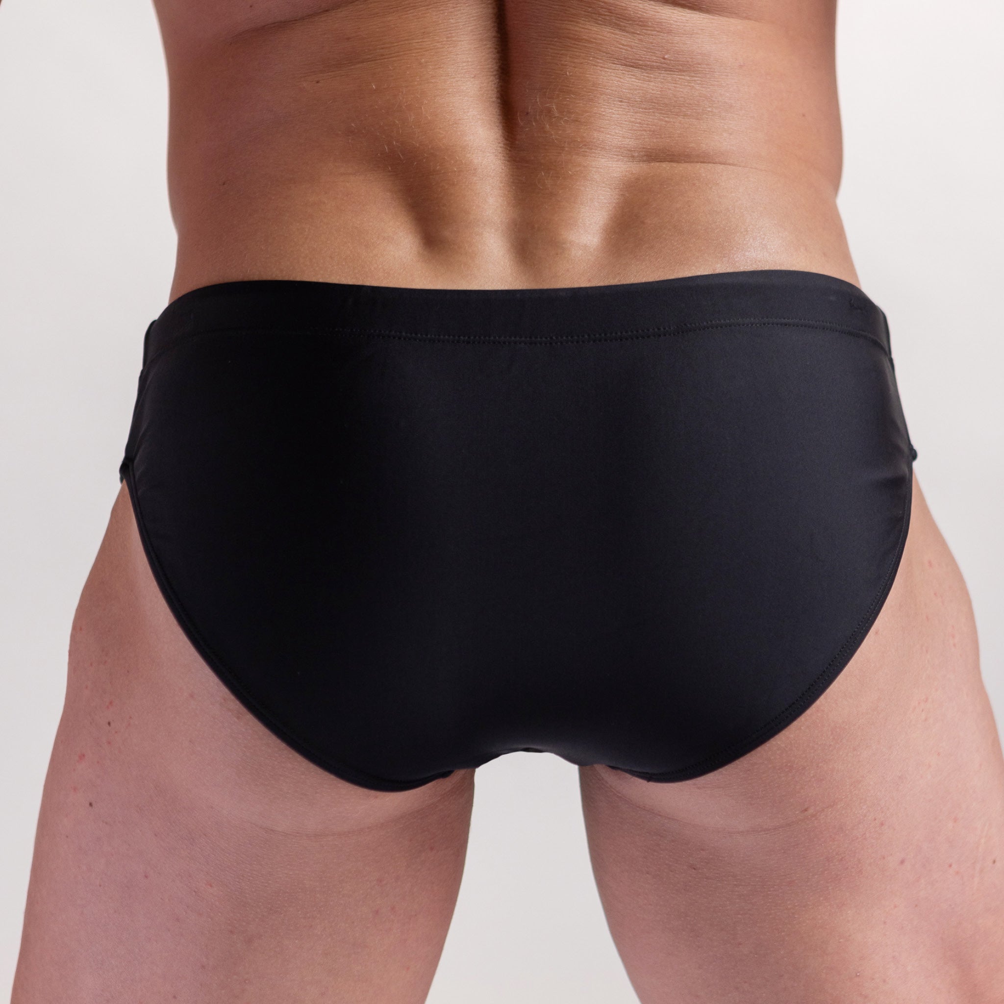 Black swimwear brief in midnight black colour back shot