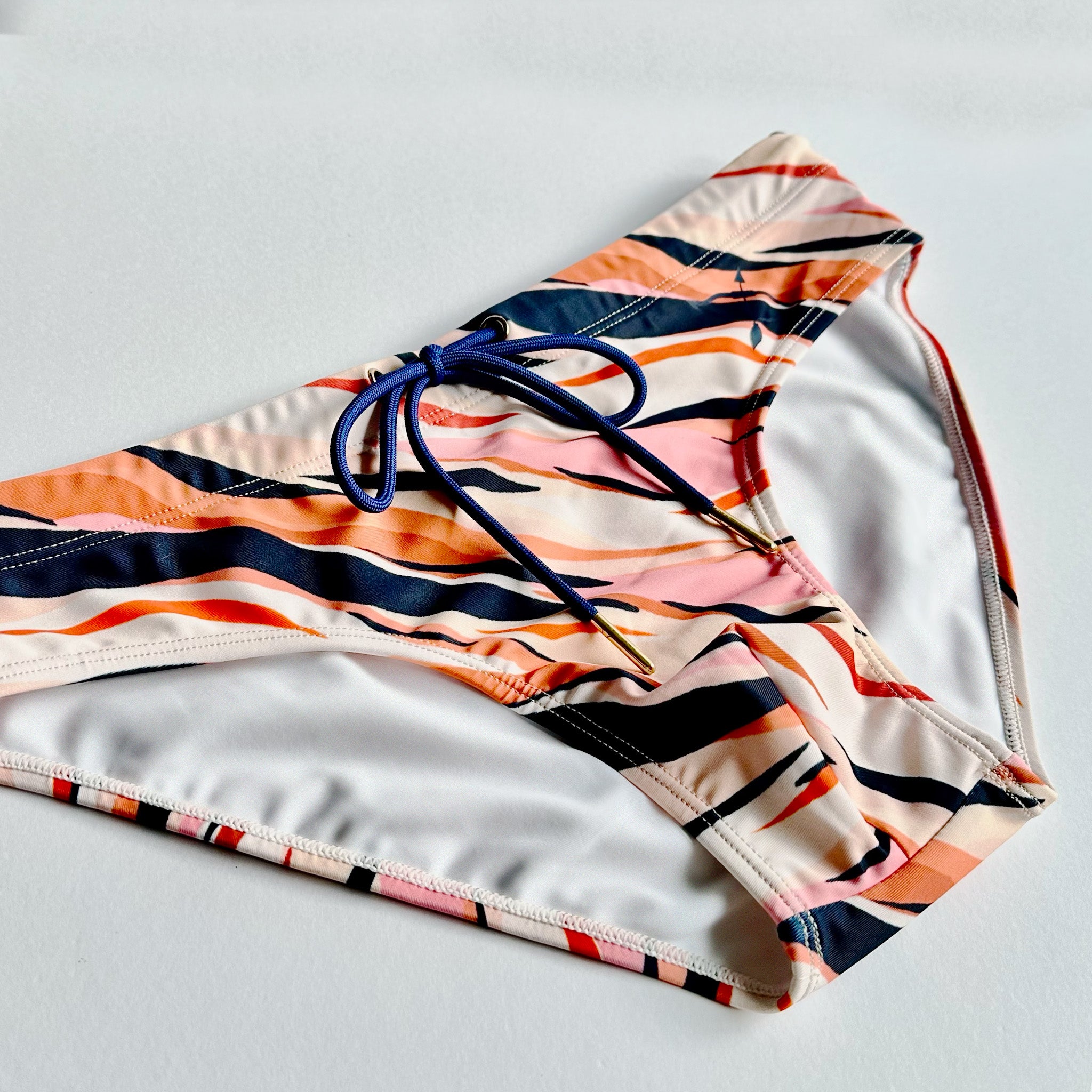 Men's Swimwear brief in pink tiger print angled close up